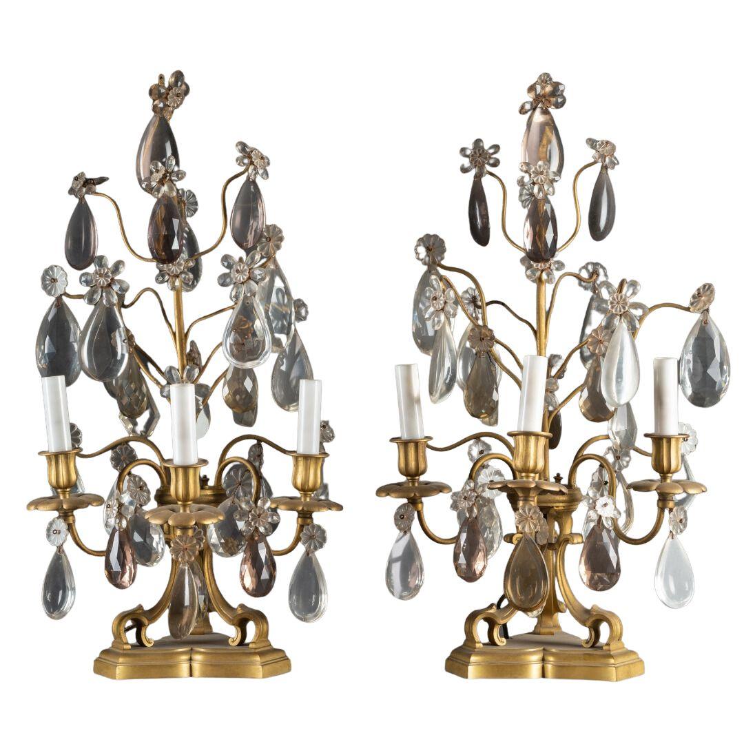 A PAIR OF FRENCH TURN OF THE CENTURY LOUIS XVI ST. CRYSTAL AND BRASS GIRANDOLES IN THE MANNER OF BAGUES. - Galerie Rosiers