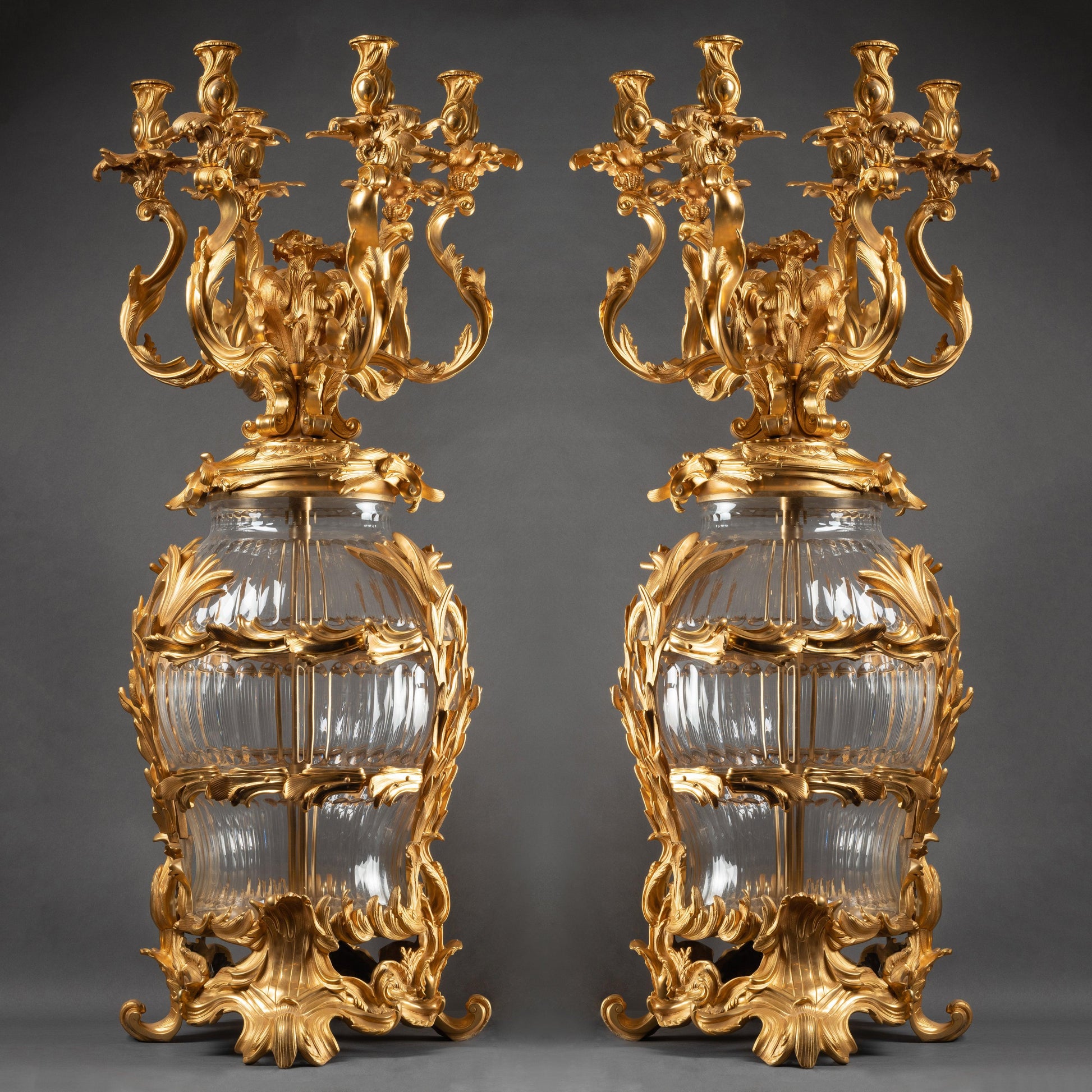AN IMPOSING PAIR OF CONTINENTAL XXth CENTURY LOUIS XV St. CUT CRYSTAL AND GILT BRONZE CANDELABRAS. - Galerie Rosiers