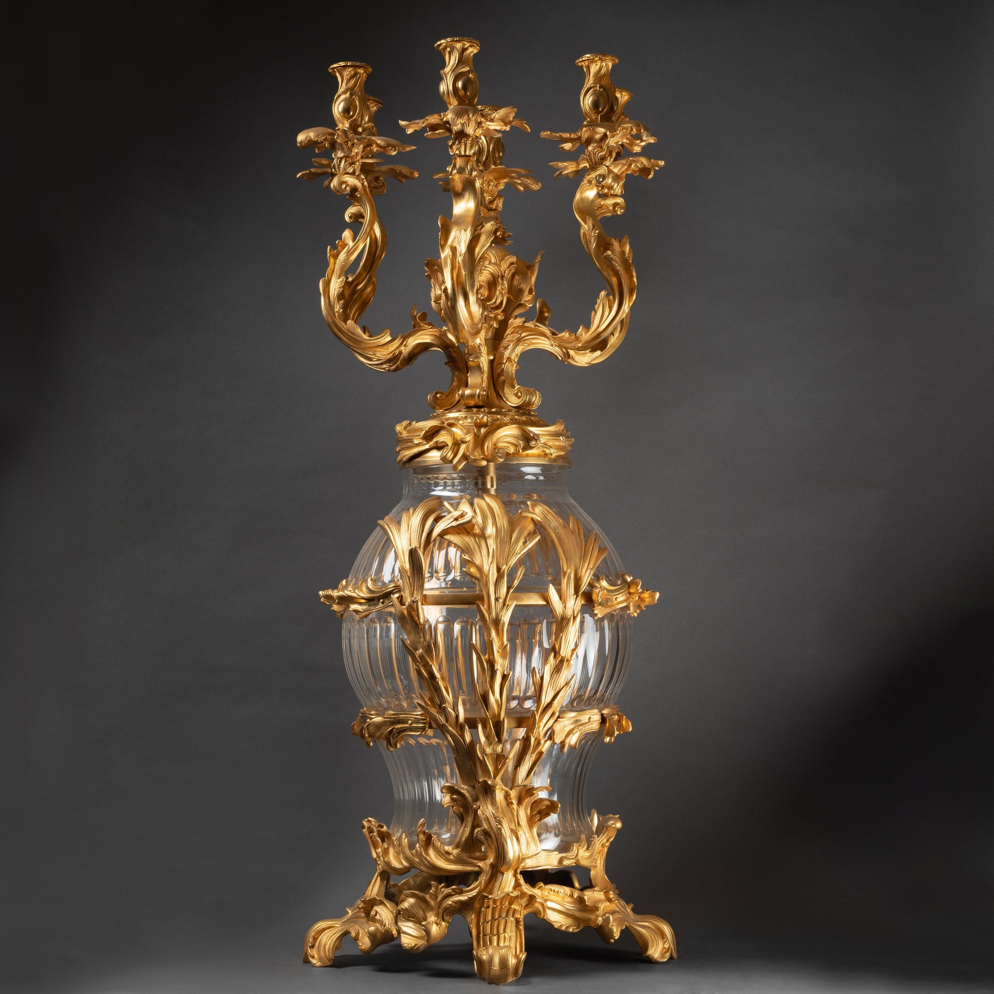 AN IMPOSING PAIR OF CONTINENTAL XXth CENTURY LOUIS XV St. CUT CRYSTAL AND GILT BRONZE CANDELABRAS. - Galerie Rosiers